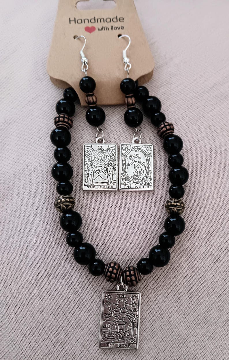 Handmade beaded assorted earrings and Tarot design bracelet and earring sets.